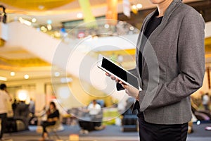 Businesswoman using digital tablet in the shopping mall.