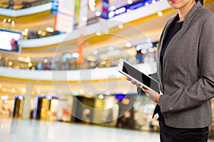 Businesswoman using digital tablet in the shopping mall.