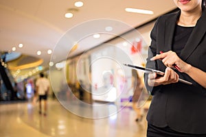 Businesswoman using digital tablet in the shopping mall.