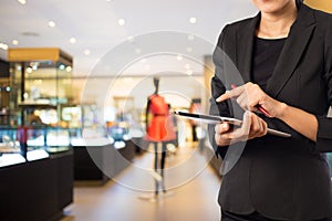 Businesswoman using digital tablet in the shopping mall.