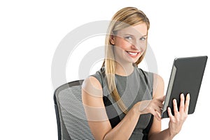 Businesswoman Using Digital Tablet While Sitting On Chair