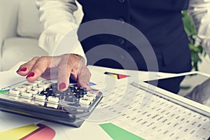 Businesswoman using an electronic calculator in her office