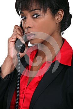 Businesswoman using a landline