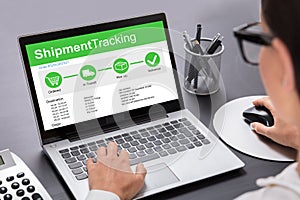 Businesswoman Using Laptop Showing Shipment Tracking Options