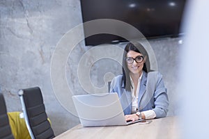 Businesswoman using a laptop in startup office