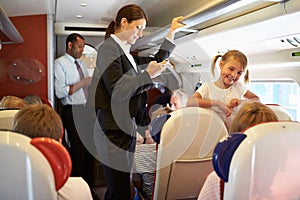 Businesswoman Using Mobile Phone On Busy Commuter Train photo