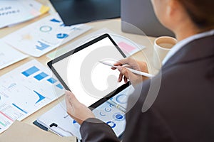 businesswoman using mockup tablet with blank white screen at office