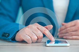 Businesswoman using smartphone, close up of hands