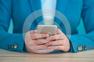 Businesswoman using smartphone, close up of hands