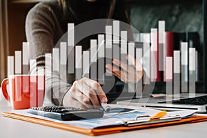 Businesswoman using tablet with laptop and document on desk in modern office.