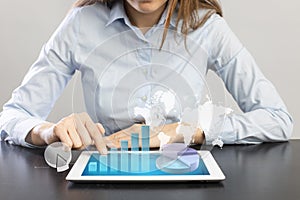 Businesswoman using tablet pc analyzing sales data and economic growth graph chart