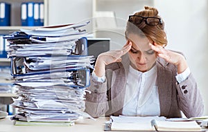 Businesswoman very busy with ongoing paperwork