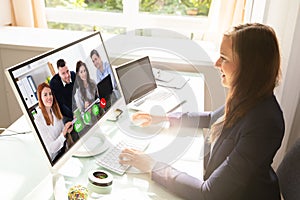 Businesswoman Videoconferencing With Her Colleagues On Computer