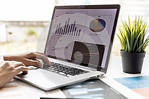 Businesswoman viewing financial data on laptop, she is reviewing financial data to bring to meetings with business partners.