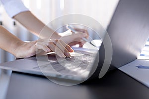 Businesswoman viewing financial data on laptop, she is reviewing financial data to bring to meetings with business partners.