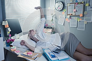 Businesswoman waking up on office desk