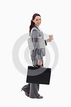 A businesswoman walking with a briefcase