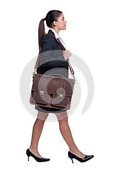 Businesswoman walking with briefcase photo