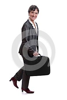 Businesswoman walking with laptop