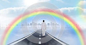 Businesswoman walking on road with surreal time clocks perspective and rainbow