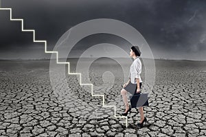 Businesswoman walking up on stairs