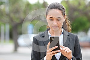 Businesswoman walking using cell phone