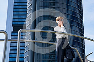 Businesswoman walks next to office building