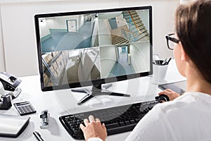 Businesswoman Watching CCTV Footage On Computer