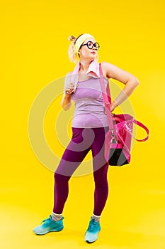 Businesswoman wearing bright clothes leaving gym after sport time