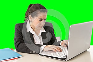 Businesswoman wearing business suit working on laptop computer green chroma key