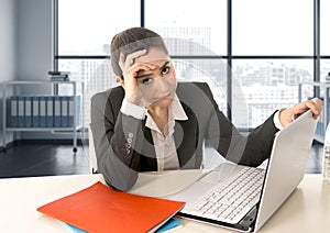 Businesswoman wearing business suit working on laptop computer at modern office room