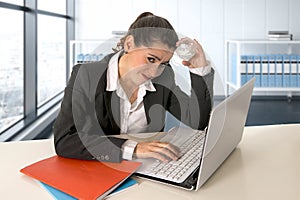 Businesswoman wearing business suit working on laptop computer at modern office room