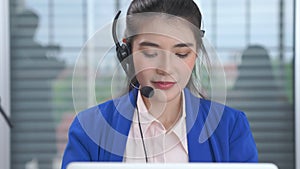 Businesswoman wearing headset working actively in office