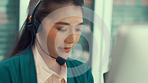 Businesswoman wearing headset working actively in office