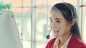 Businesswoman wearing headset working actively in office