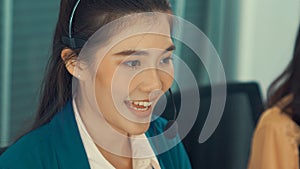 Businesswoman wearing headset working actively in office