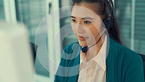 Businesswoman wearing headset working actively in office