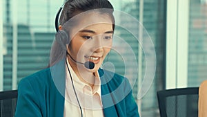 Businesswoman wearing headset working actively in office