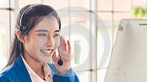 Businesswoman wearing headset working actively in office