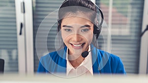 Businesswoman wearing headset working actively in office