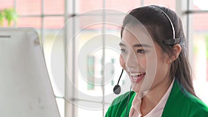 Businesswoman wearing headset working actively in office