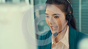 Businesswoman wearing headset working actively in office