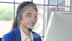 Businesswoman wearing headset working actively in office