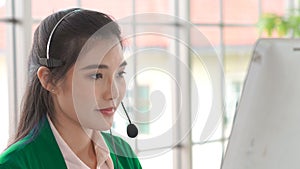 Businesswoman wearing headset working actively in office