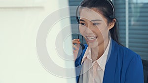 Businesswoman wearing headset working actively in office