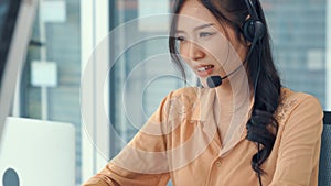 Businesswoman wearing headset working actively in office