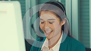 Businesswoman wearing headset working actively in office