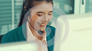 Businesswoman wearing headset working actively in office