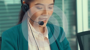 Businesswoman wearing headset working actively in office