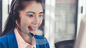 Businesswoman wearing headset working actively in office